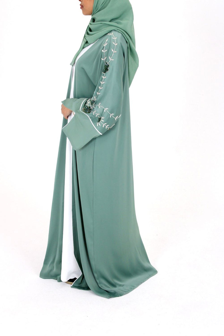 Topaz green open abaya over the white inner slip dress
