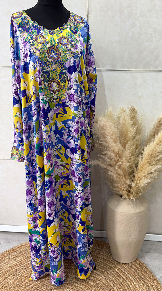 Woman wearing Amani's multi-colour floral mukhawar jalabiya dress with scarf