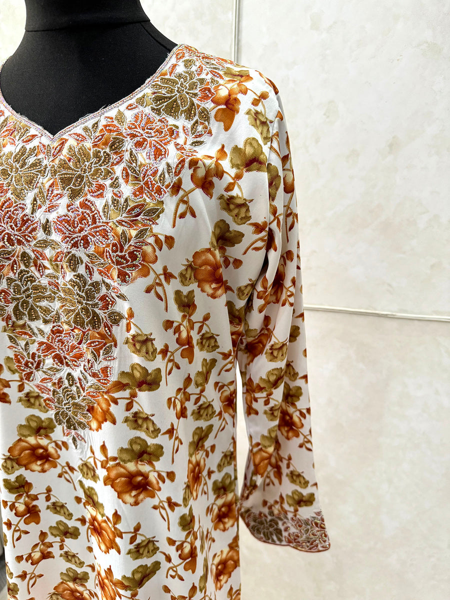Full-length view of Amani's ocher orange floral mukhawar dress