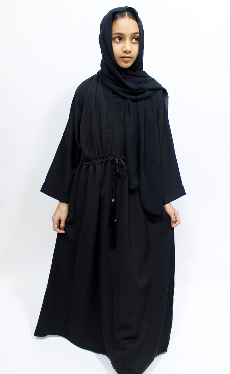 Full-length view of Amani's black girls' draw string abaya