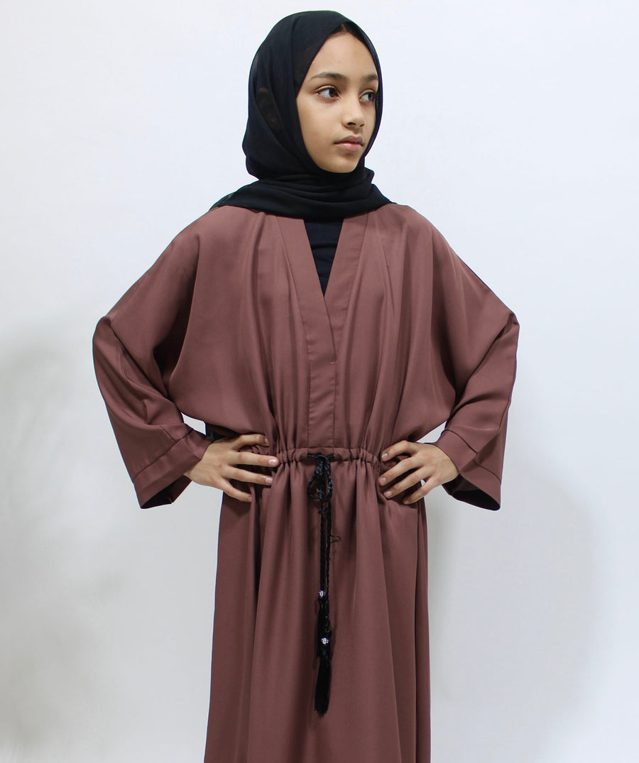 Full-length view of Amani's dark blush girls' draw string abaya