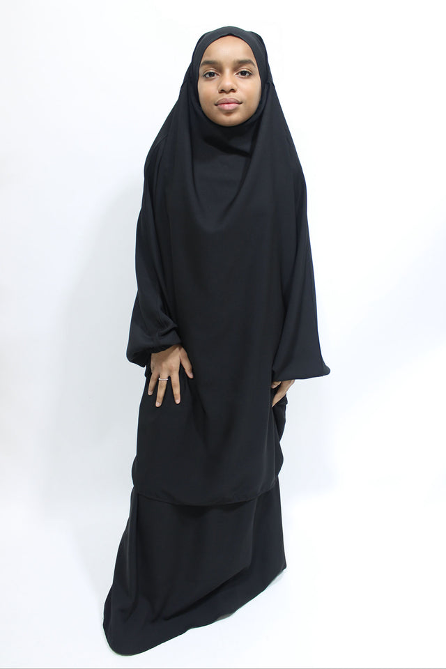 Girl wearing Amani's black jilbab and skirt set with half-jilbab top