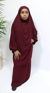 Girl wearing Amani's burgundy jilbab and skirt set with half-jilbab top