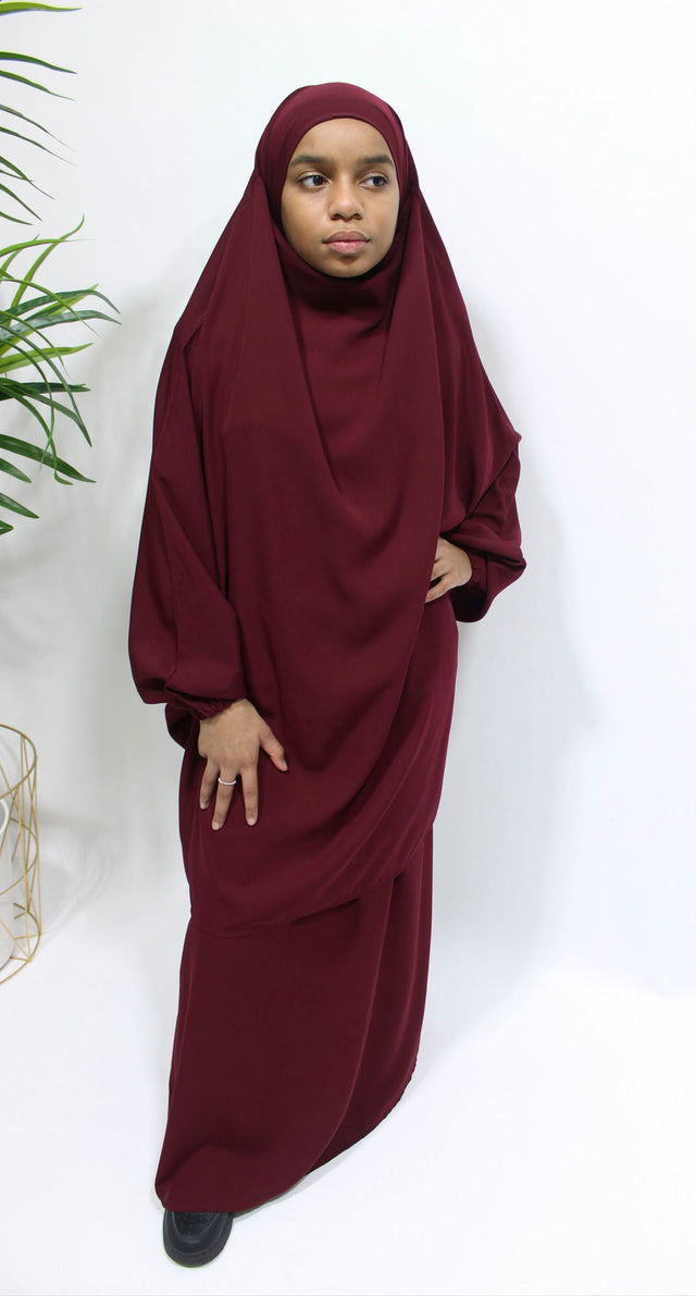 Girl wearing Amani's burgundy jilbab and skirt set with half-jilbab top