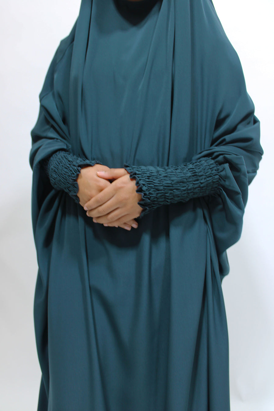 Full-length view of Amani's deep teal girls' ruched cuffs jilbab