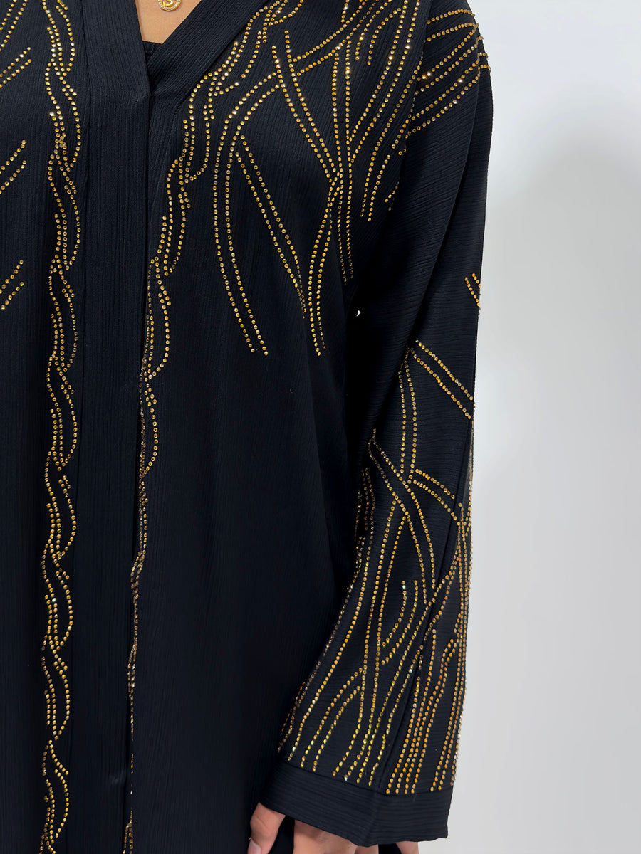 Black open abaya layered over an inner dress