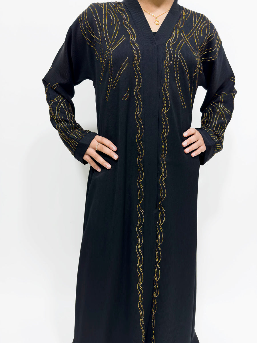 Full-length view of Amani's black gold embellished open abaya