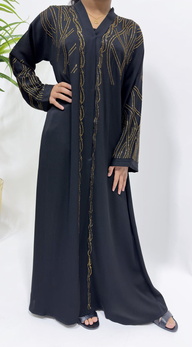 Girl wearing Amani's black gold embellished open abaya with scarf