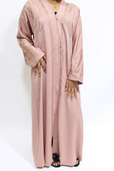 Girl wearing Amani's blush gold embellished open abaya with scarf