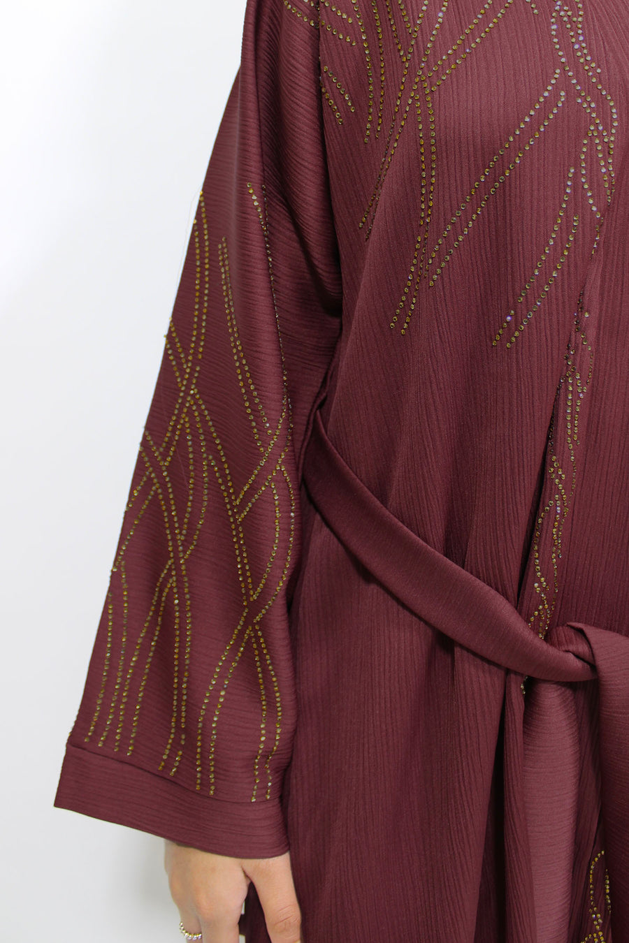 Plum open abaya layered over an inner dress