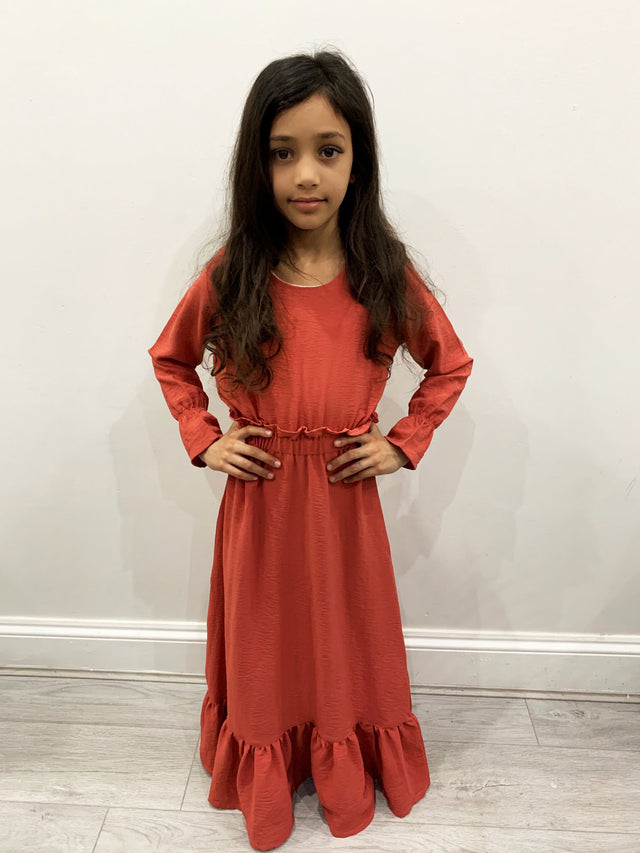 Girl wearing Amani's Haya coral long-sleeve maxi dress