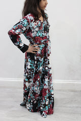 Girl wearing Amani's burgundy floral umbrella-cut kids maxi dress