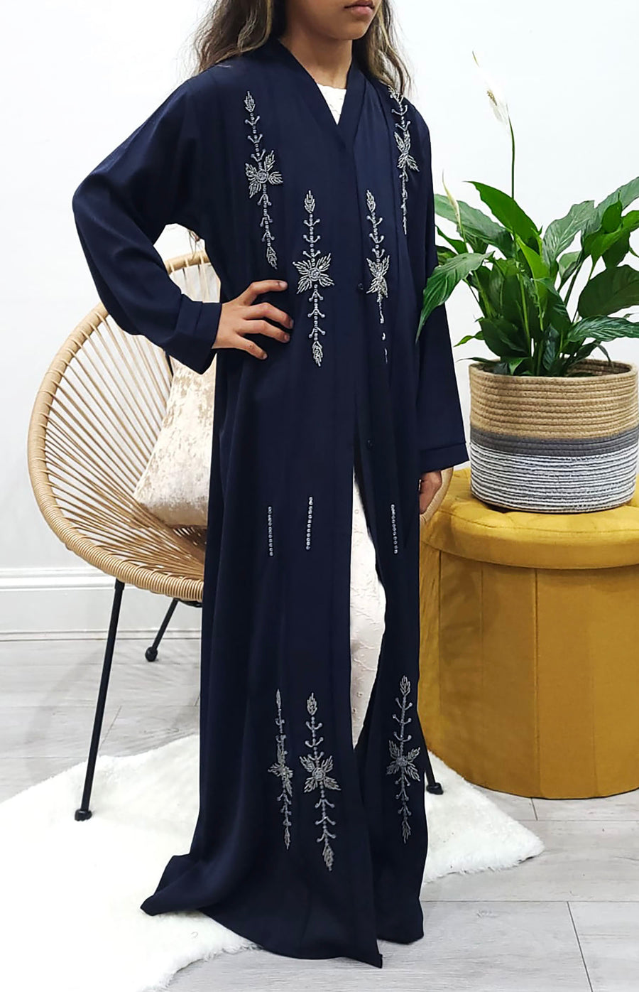 Hand-stitched grey bead detail on the navy girls' open abaya