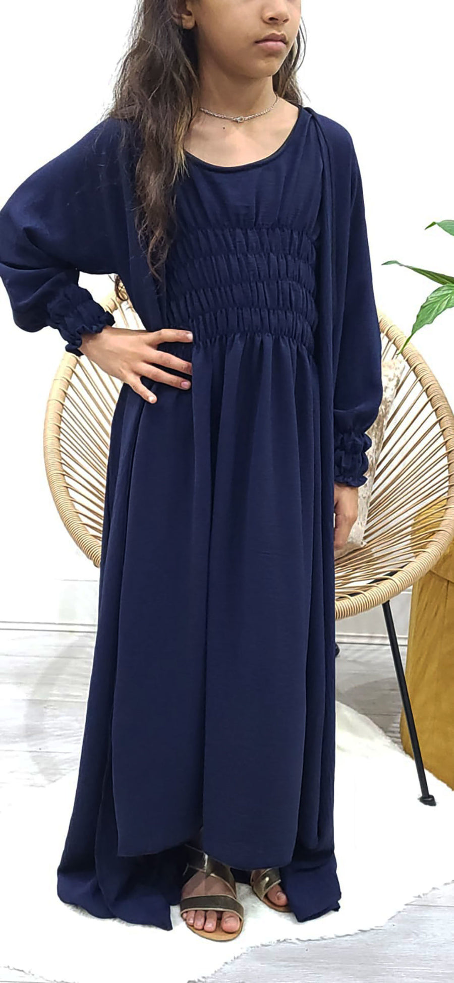 Girl wearing Amani's navy blue jacket-style abaya set with belt and scarf