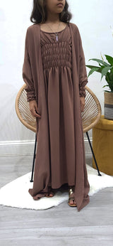Girl wearing Amani's russett brown jacket-style abaya set with belt and scarf