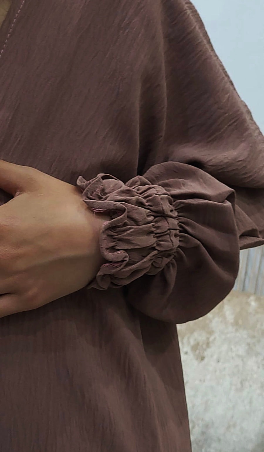 Full-length view of Amani's russett brown jacket-style abaya set