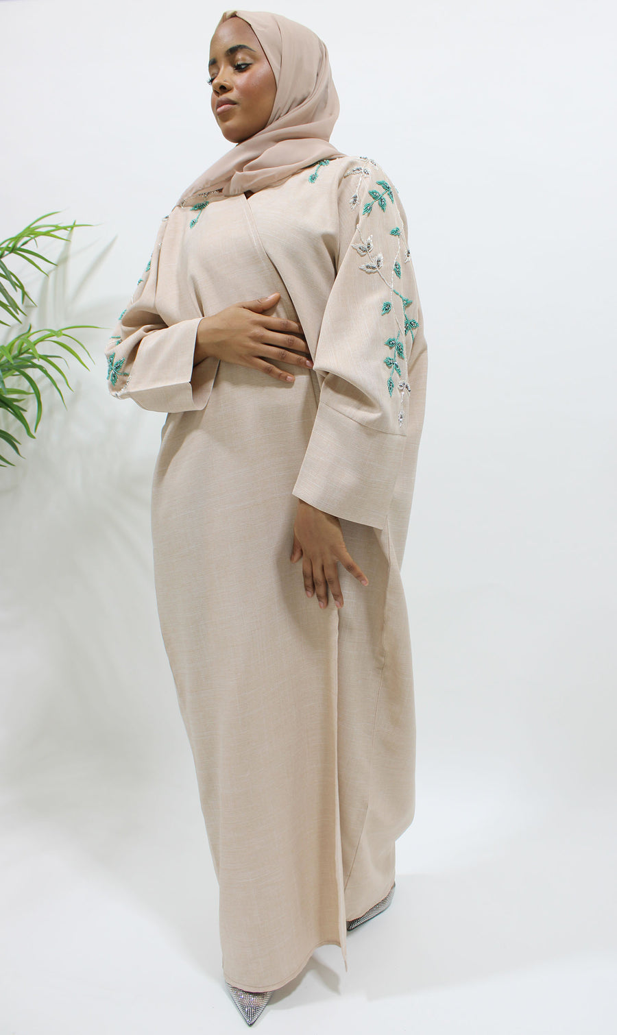 Nude bisht abaya draping gracefully from the shoulders with matching hijab