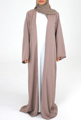 Woman wearing Amani's mocha duster style open abaya with scarf