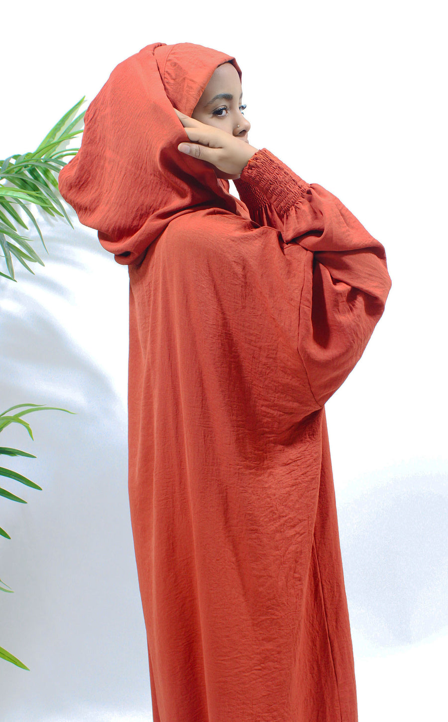 Detail of the double hood on the orange red one-piece prayer abaya