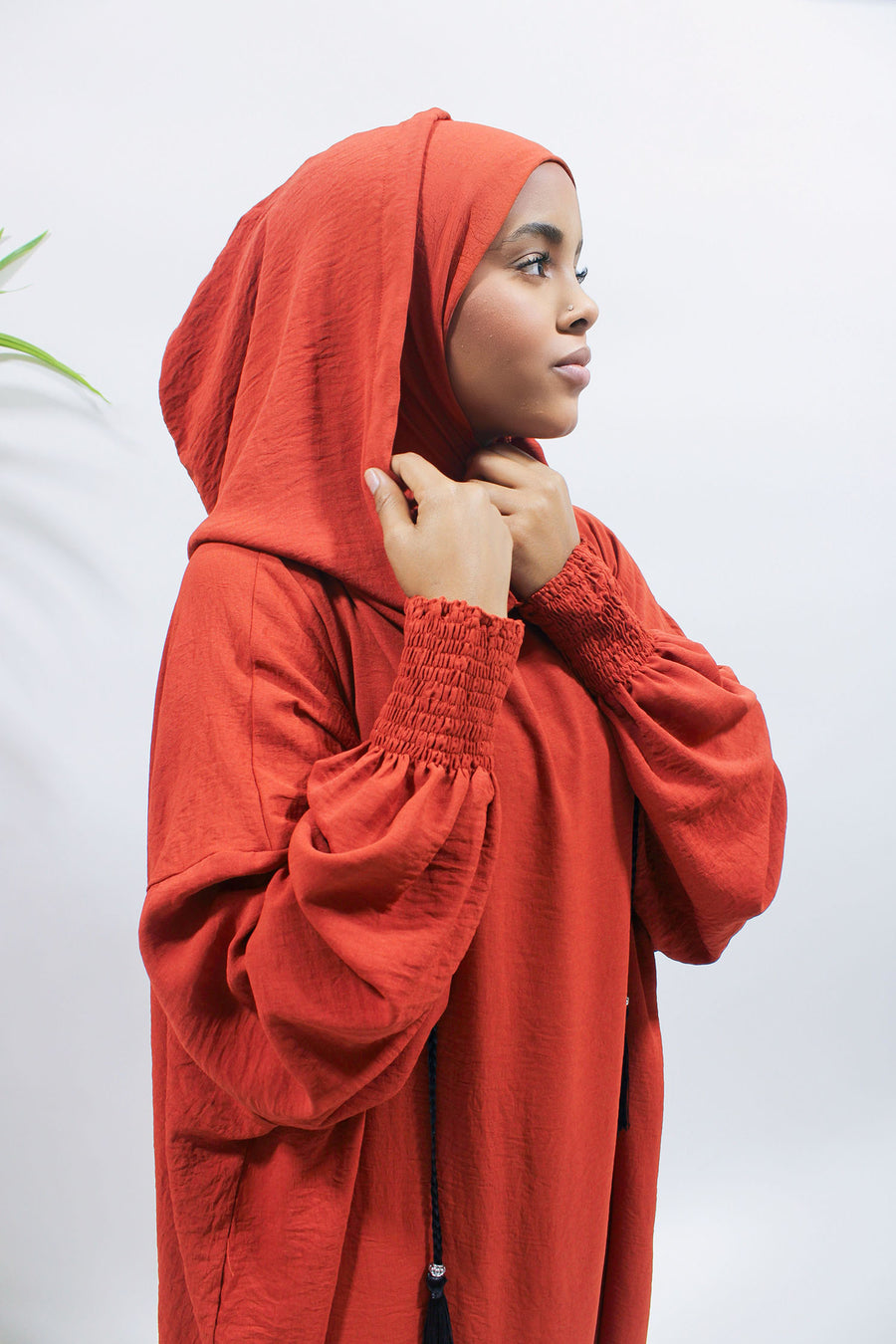 Orange red hooded prayer abaya showing its full-length relaxed cut