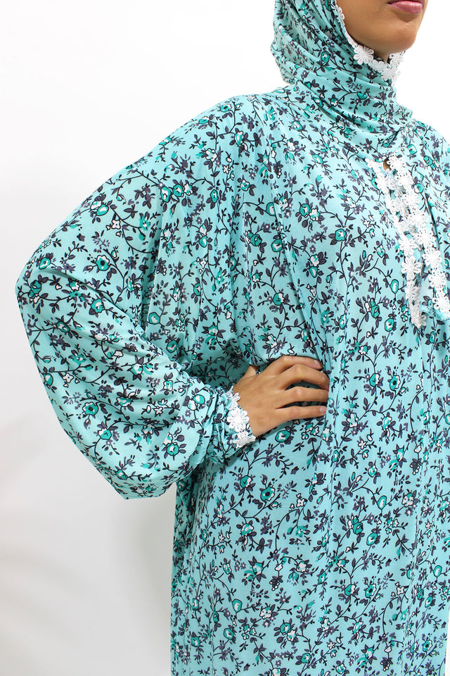 Bright turquoise lace trim floral prayer dress with attached hijab, front view