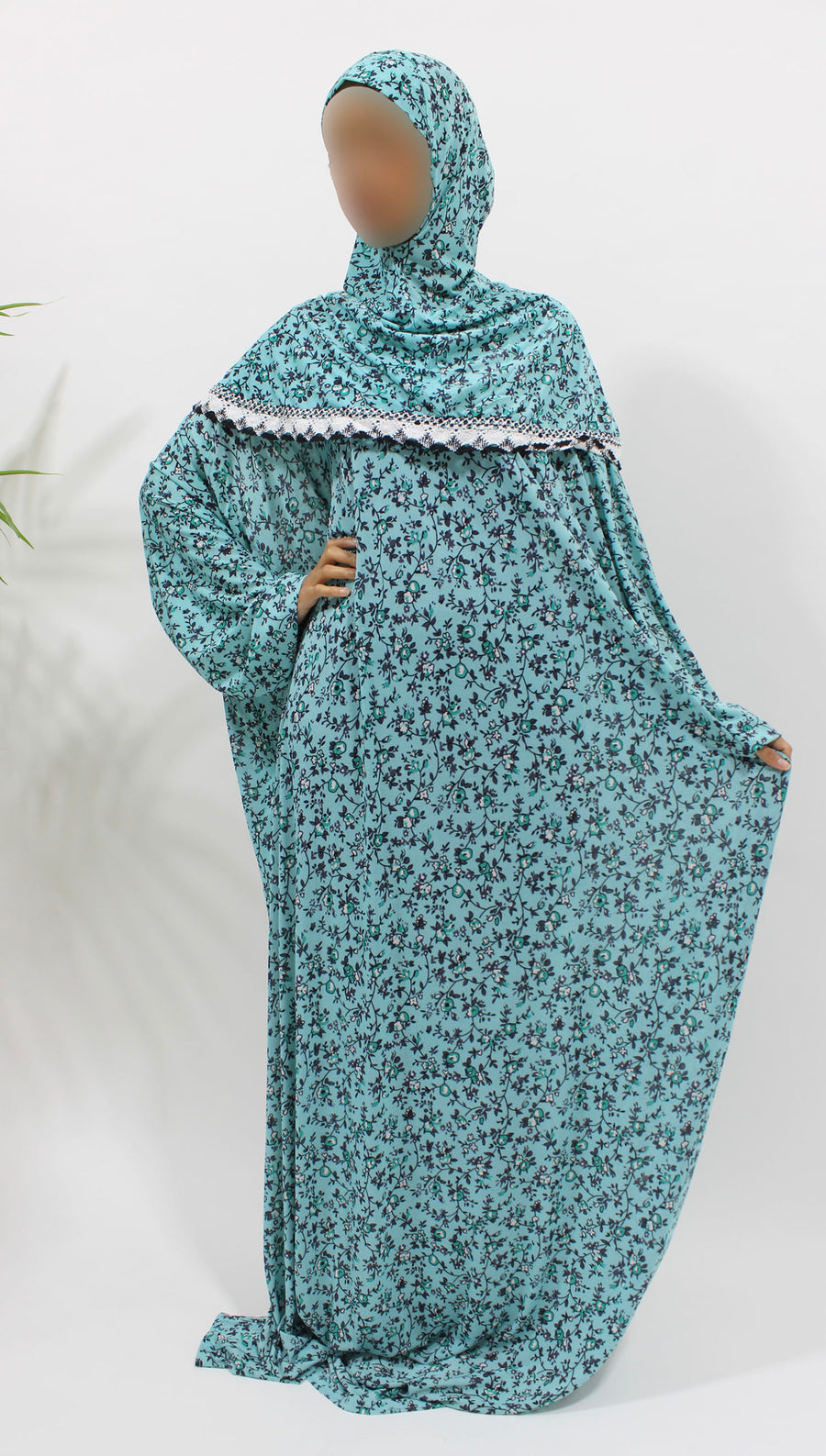 Bright turquoise floral jersey prayer dress showing the attached hijab
