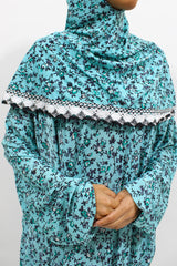 Bright turquoise floral slip-on jersey prayer dress with attached hijab, front view