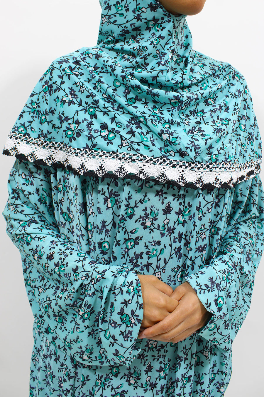 Bright turquoise floral slip-on jersey prayer dress with attached hijab, front view