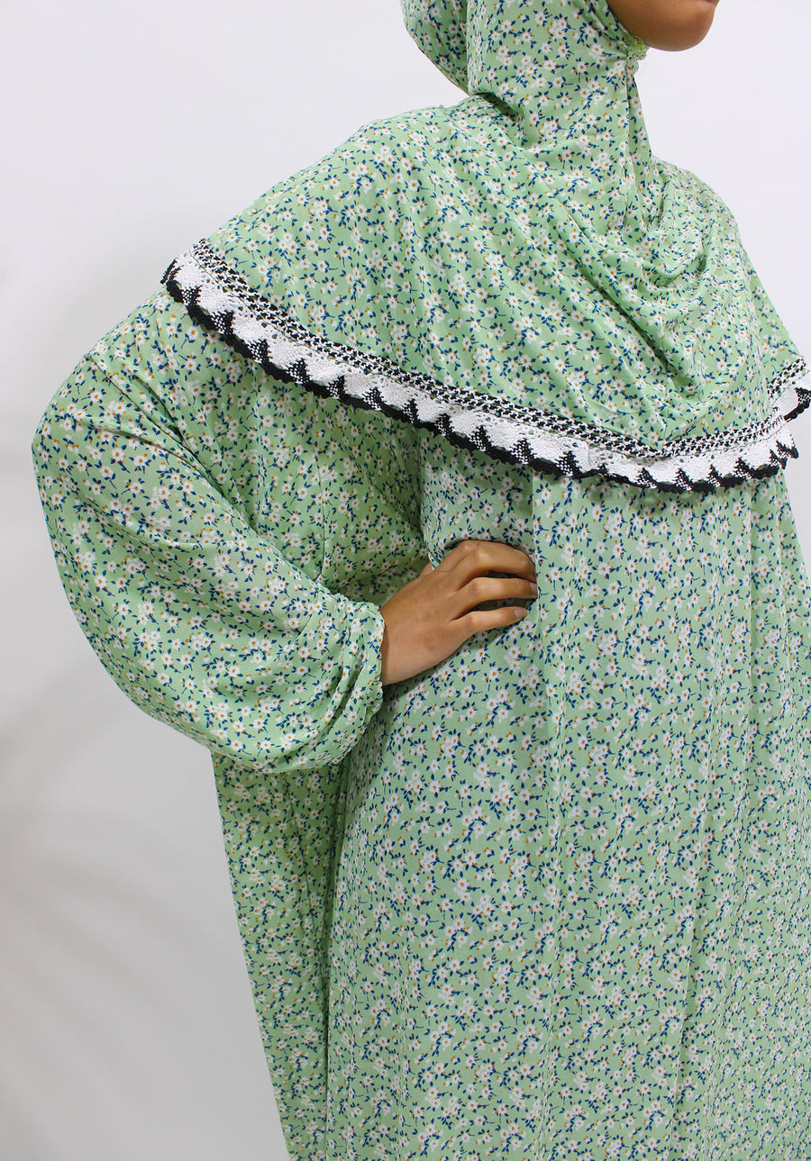 Soft green floral slip-on jersey prayer dress with attached hijab, front view