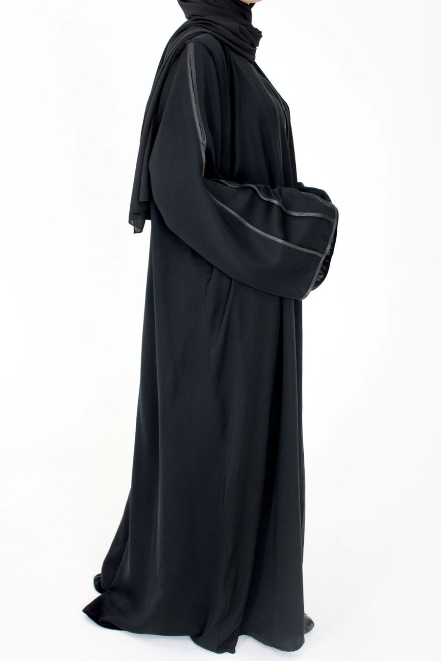 Black open abaya layered over an inner dress