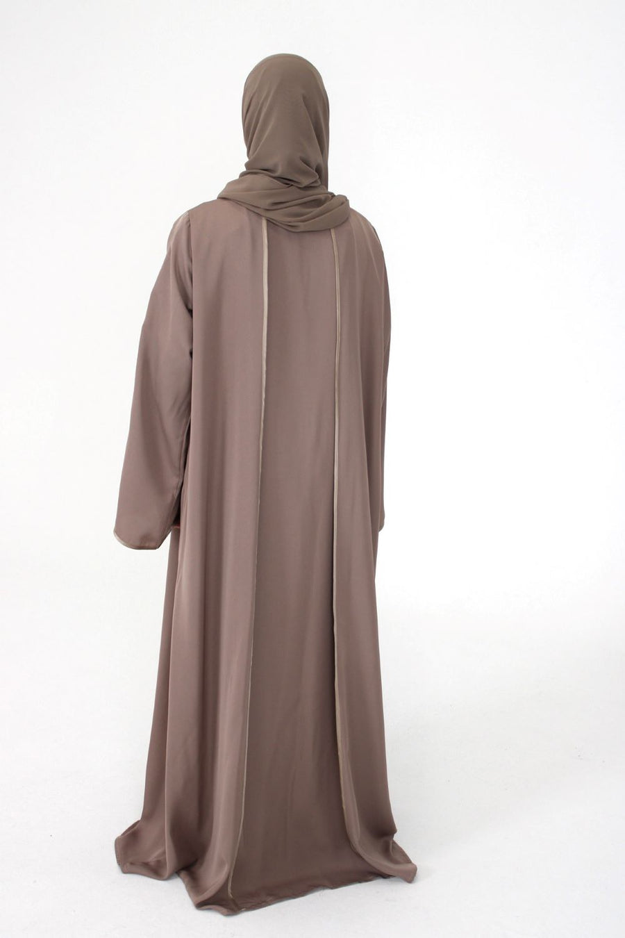 Full-length view of Amani's rose taupe open abaya with piping