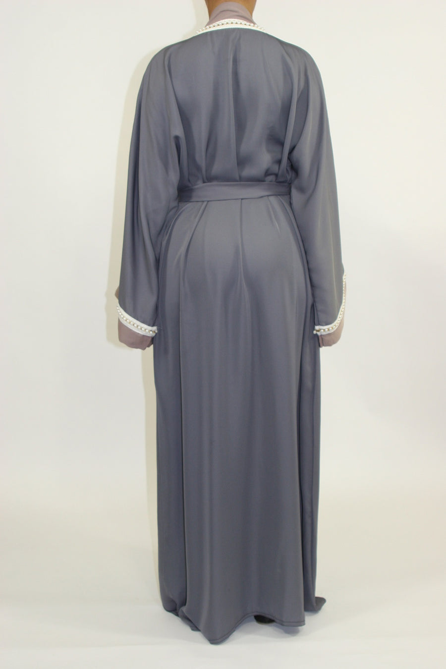 Close-up of the pearl embellishments on the grey abaya front and sleeves