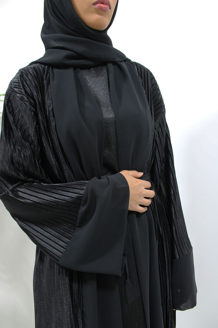Black pleated satin open abaya shown front-on with matching belt and hijab