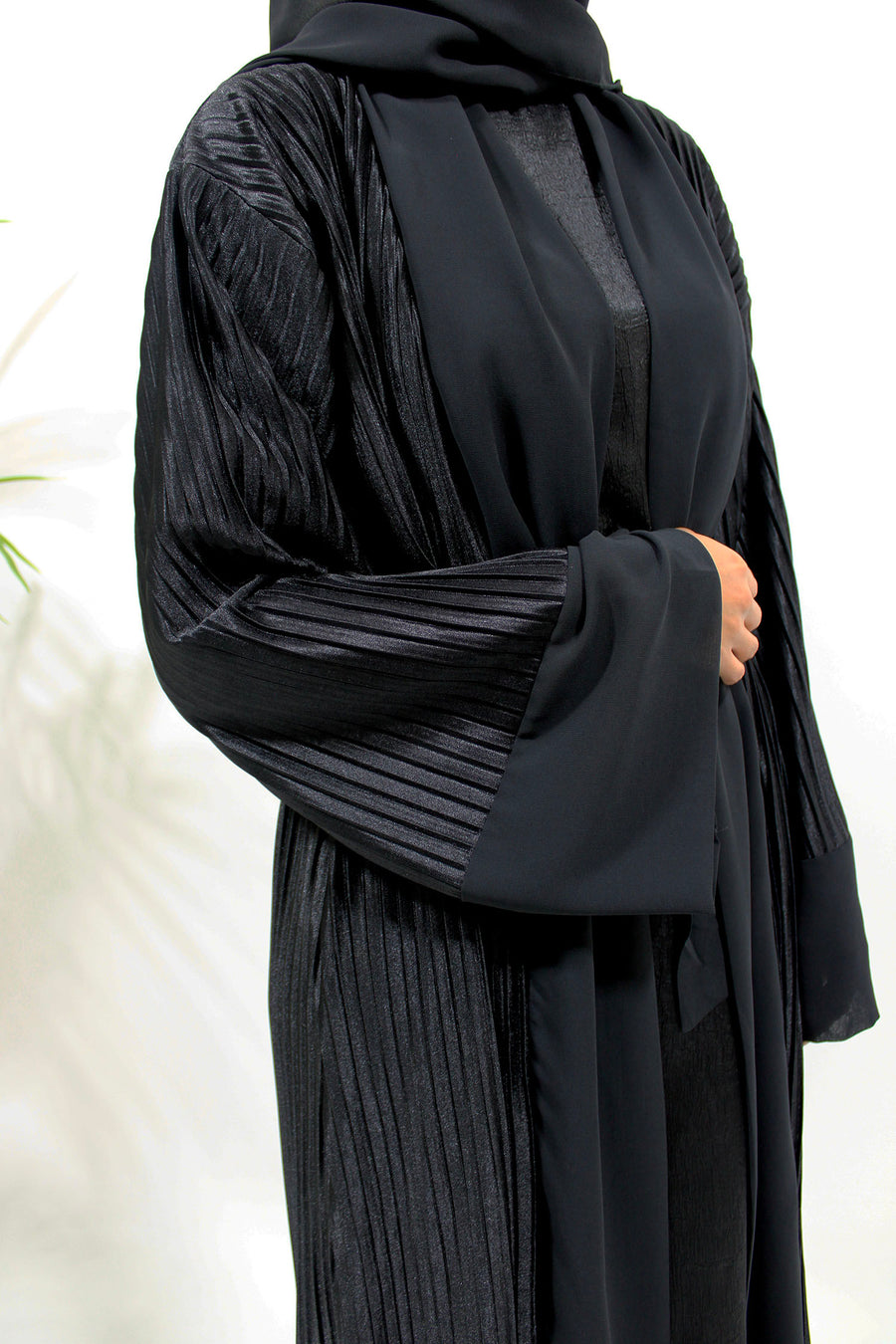 Close view of the black pleated satin fabric and soft sheen