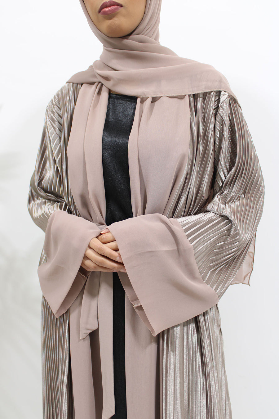 Side view of the pink nude pleated satin open abaya showing soft vertical pleats