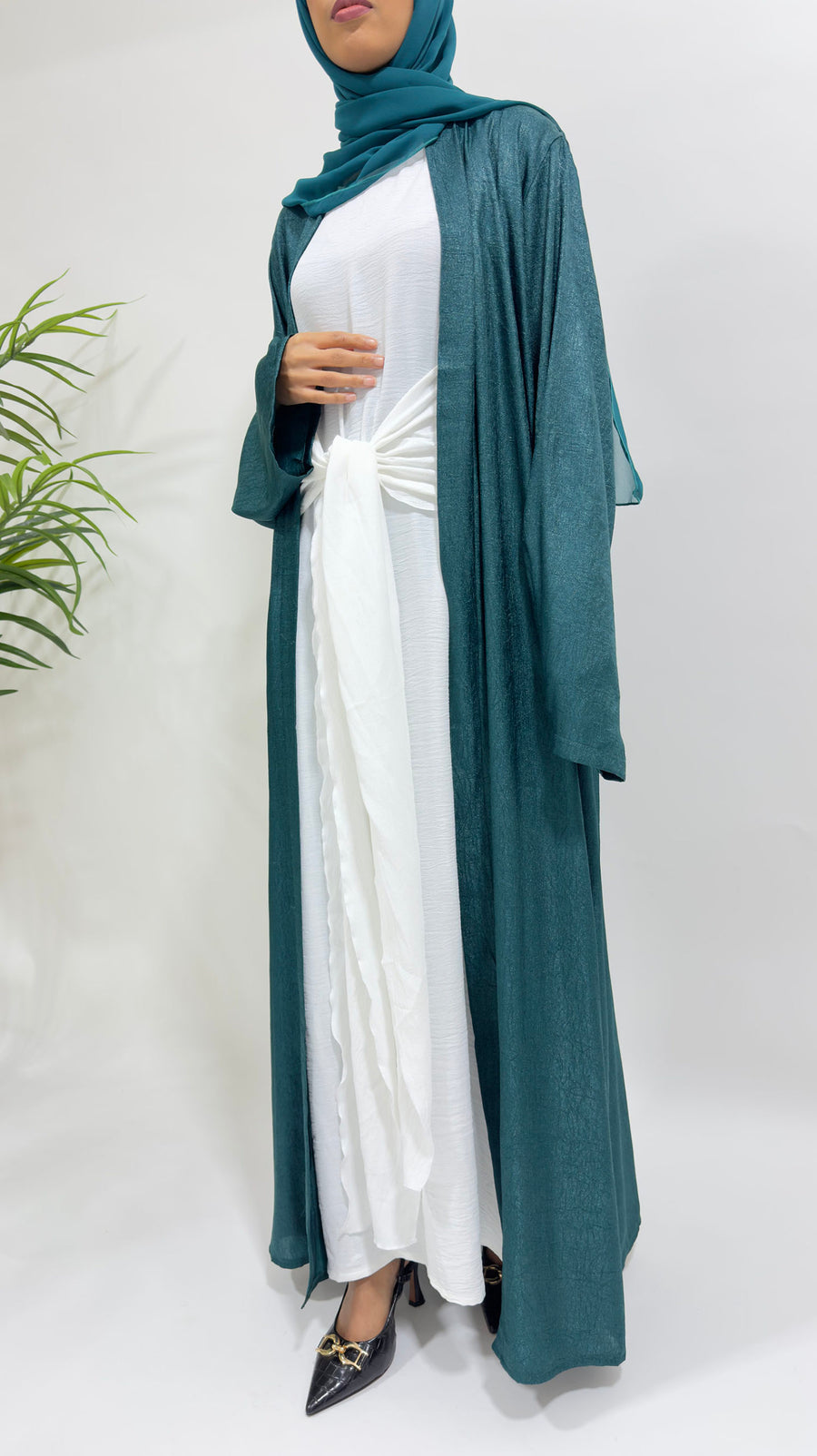 Side view of the teal shimmer open jacket over the white inner dress