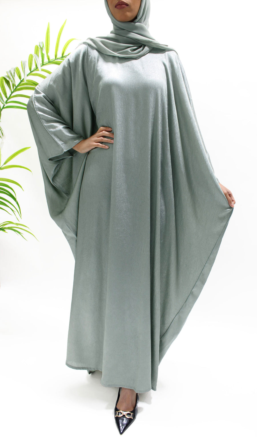 Side view of the sage farasha abaya showing its soft flowing drape