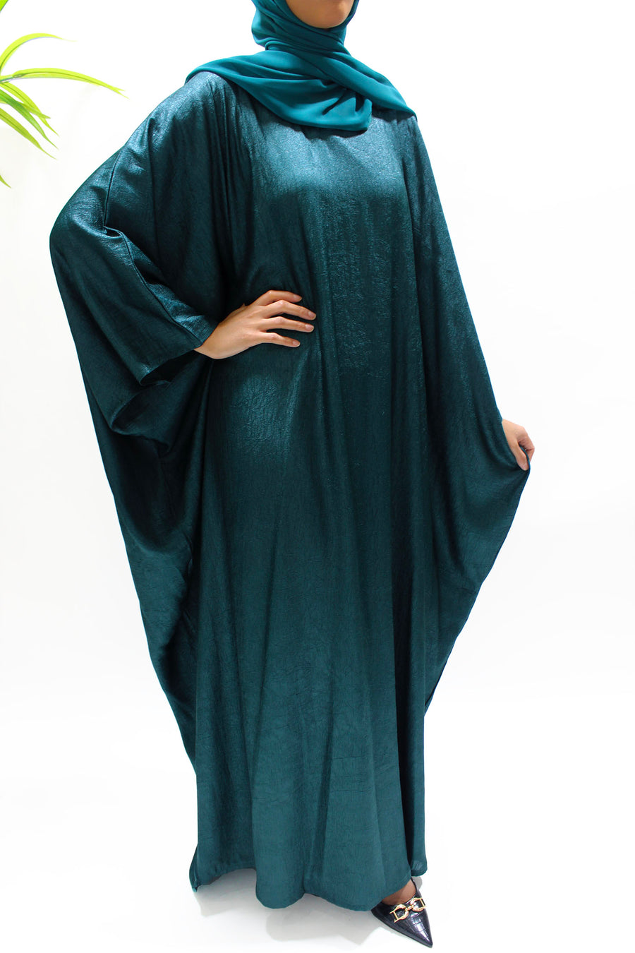Full-length view of the teal farasha abaya with matching hijab