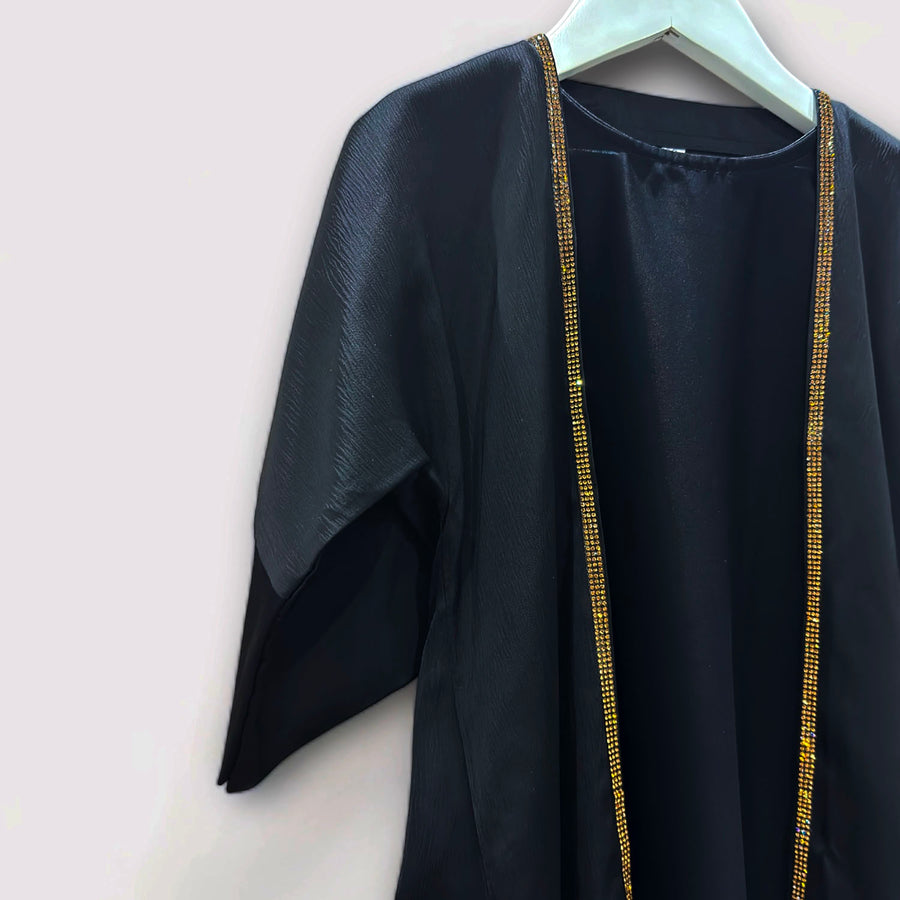 Gold embellishment detail on the toddler black abaya