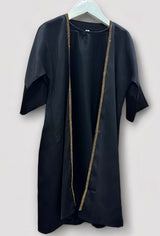 Toddler wearing Amani's black and gold embellished abaya set with hijab