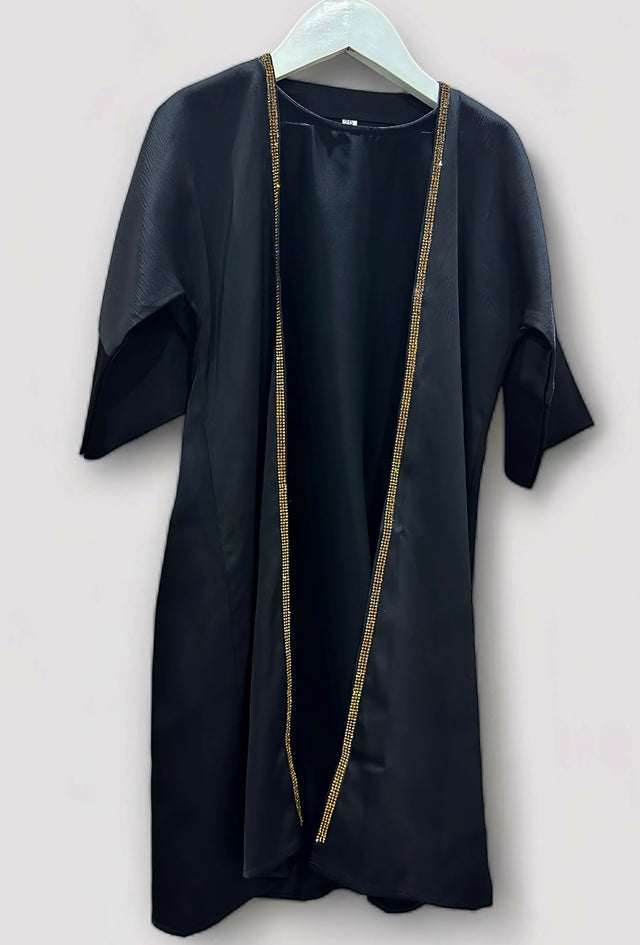 Toddler wearing Amani's black and gold embellished abaya set with hijab