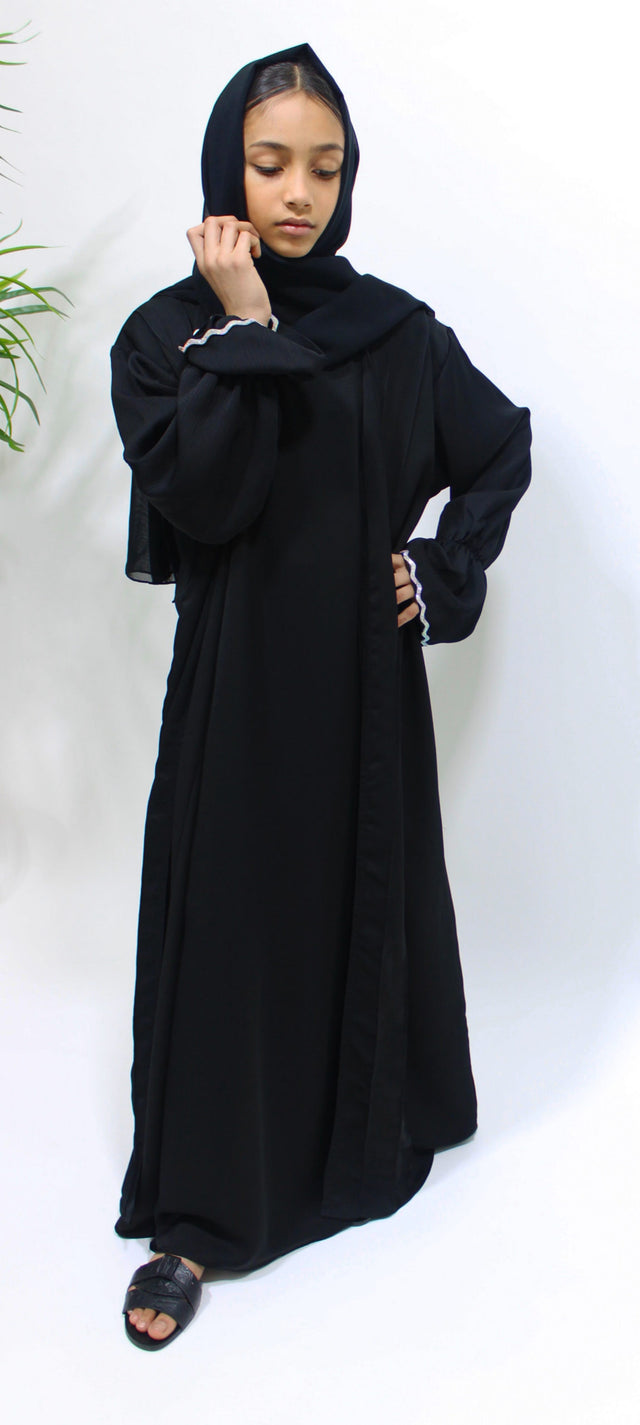 Girl wearing Amani's black two piece style open abaya with scarf