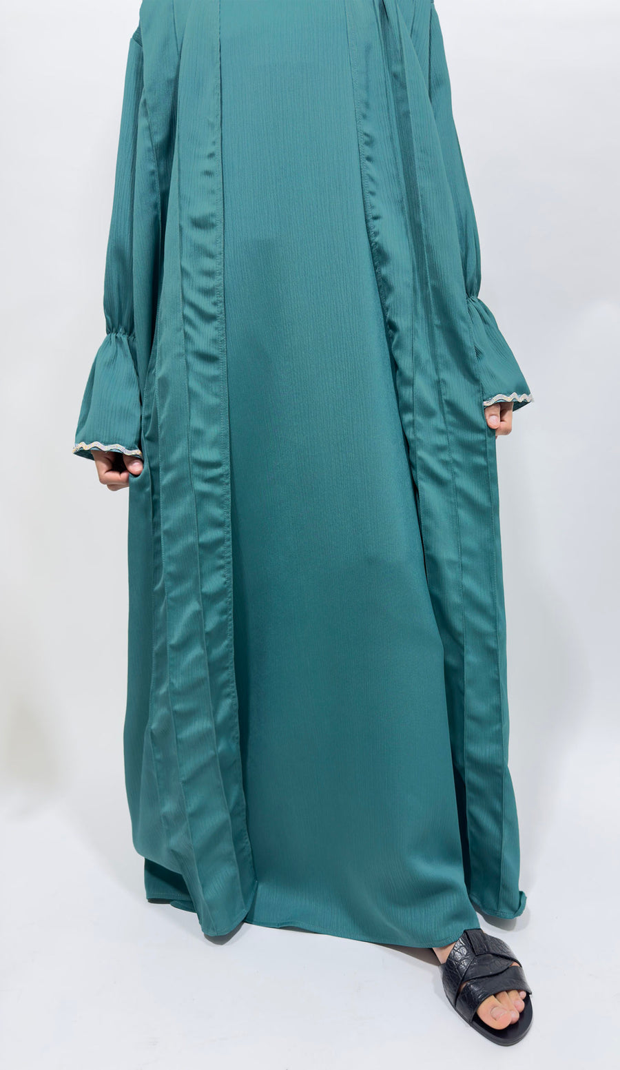 Embellished cuff detail on the turquoise girls' open abaya