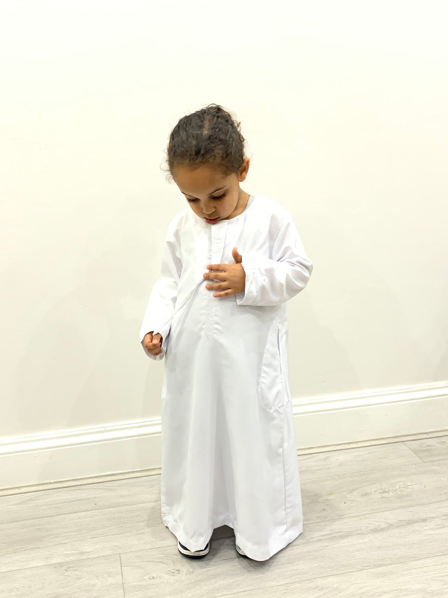White kids kandura thobe showing removable tassel detail