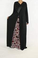 Black and burgundy paisley jersey abaya with V-neckline and button closure, front view