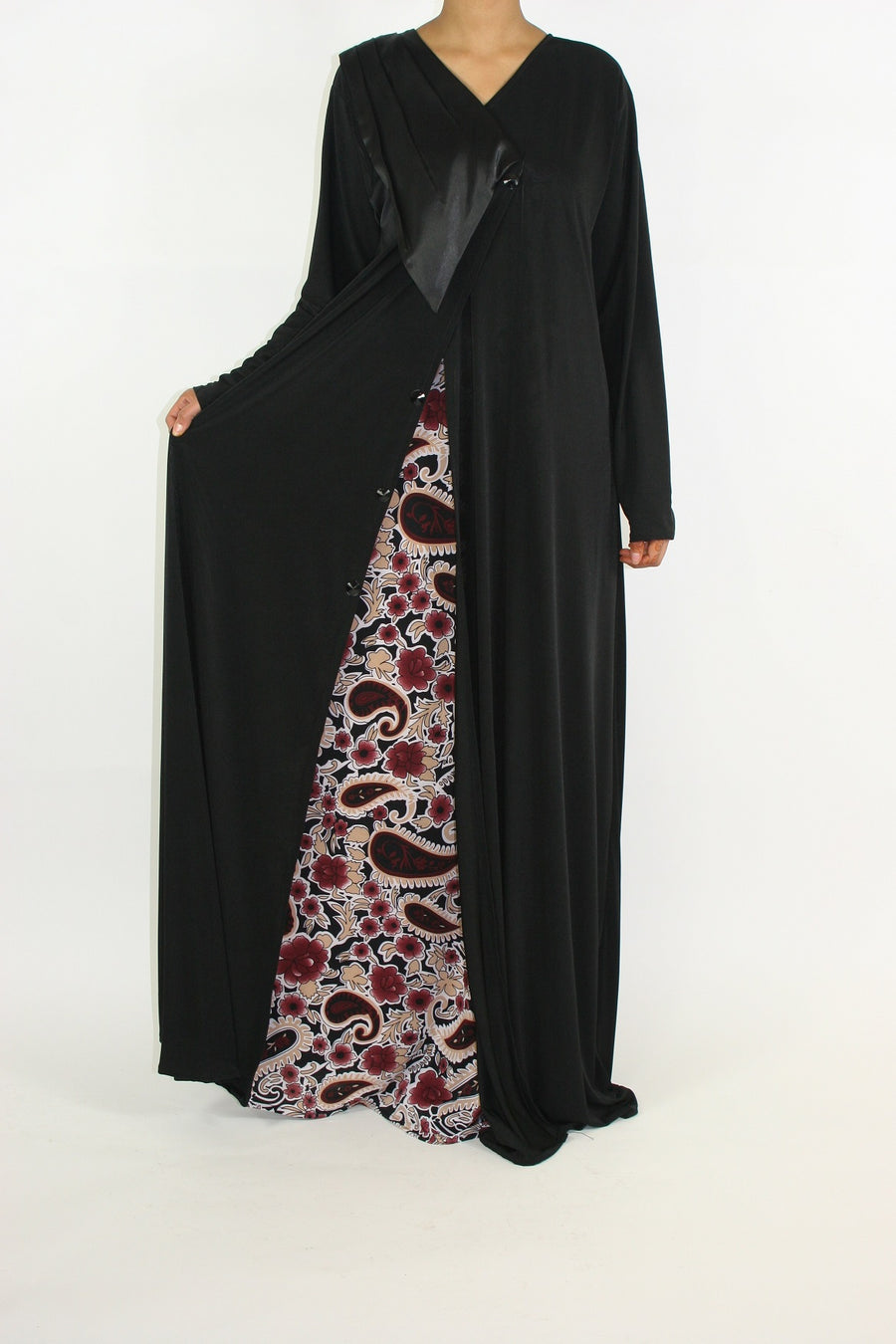 Black and burgundy paisley jersey abaya with V-neckline and button closure, front view
