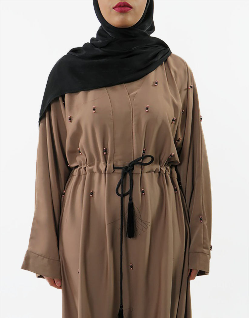Light brown Neda abaya showing beaded cuff detail