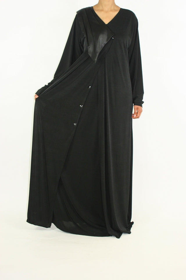 Azzah black jersey abaya with V-neckline, button closure and satin flap, front view