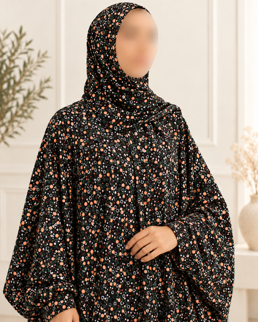 Close-up of black peach white and green floral prayer dress, matching hijab and lace-free sleeve finish