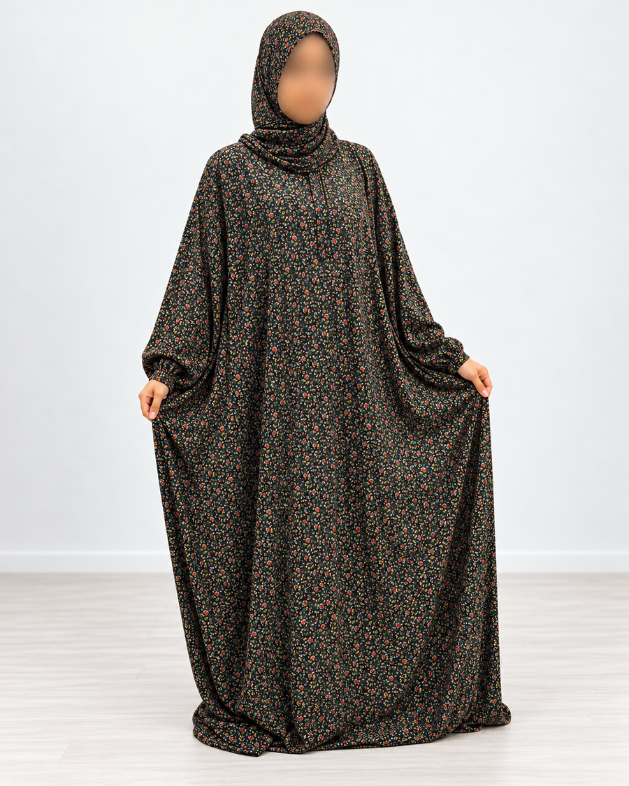 Front view of black micro-floral jersey prayer dress with matching attached hijab and generous flowing coverage, without lace